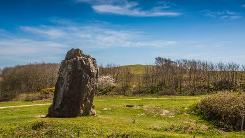 The solitary Long Stone on Mottistone Estate in cold spring sunshine
